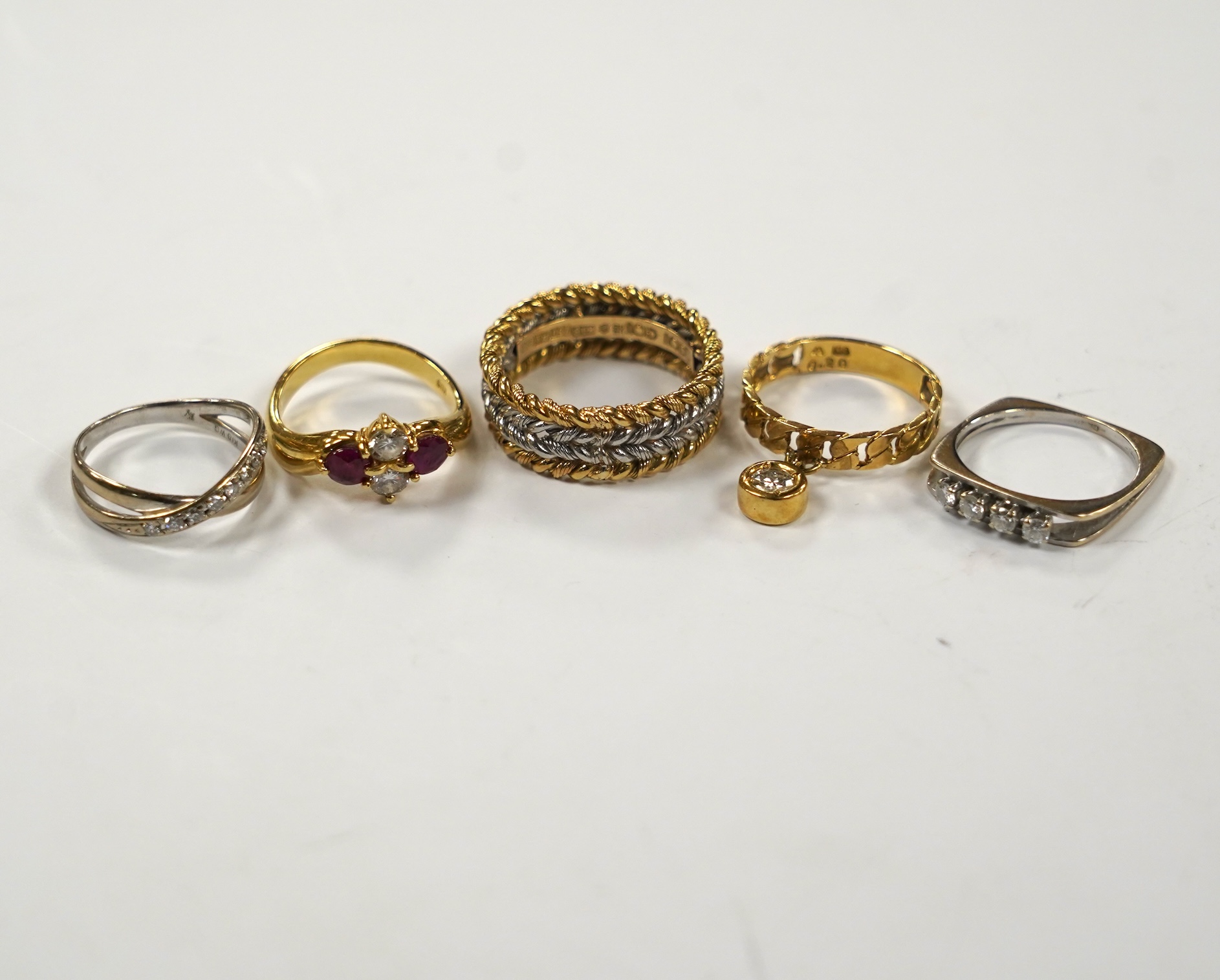 A modern Chou Chou 18k and Pm four band rope twist ring, size Q, A french white metal (18ct mark) and four stone diamond ring, an 18k two stone ruby and two stone diamond set ring, an 18k white metal and diamond chip set